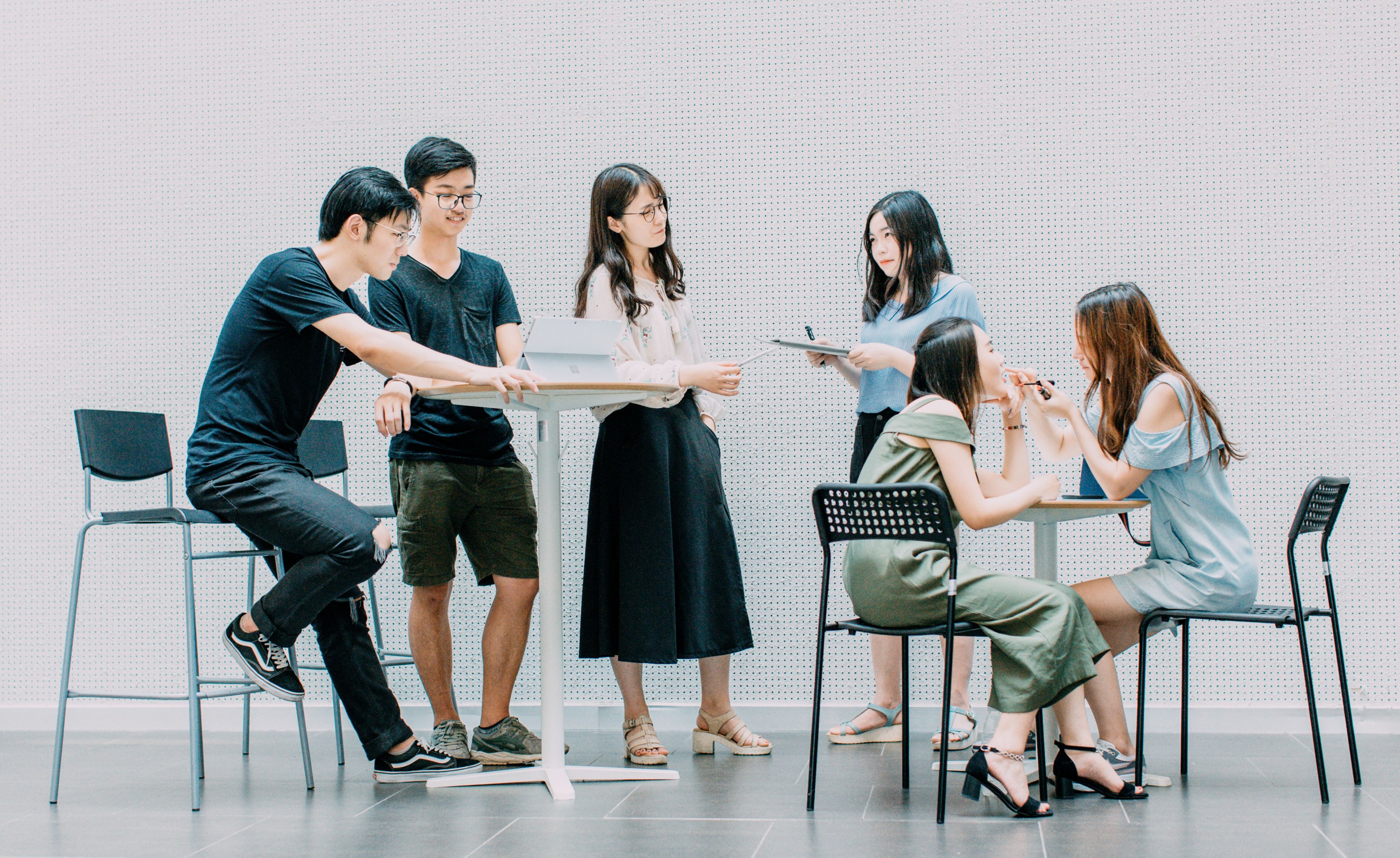 two men and four women meeting in office